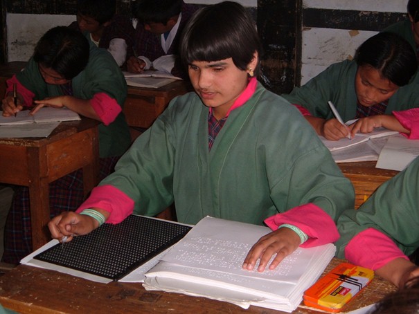 photo: Blind pupil in class at school, reading Braille.