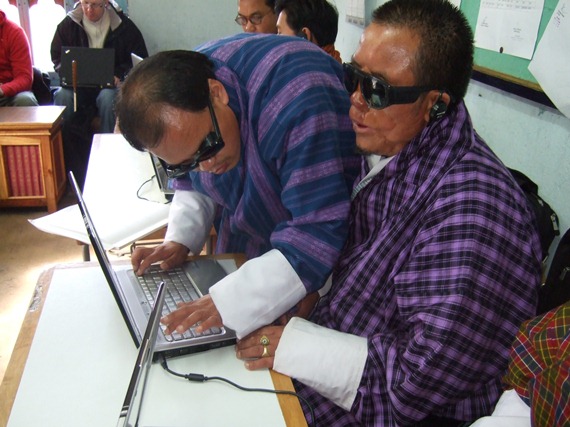 Photo: Kuenga Chhoegyel helping a blind student during ICT training at NIVI.